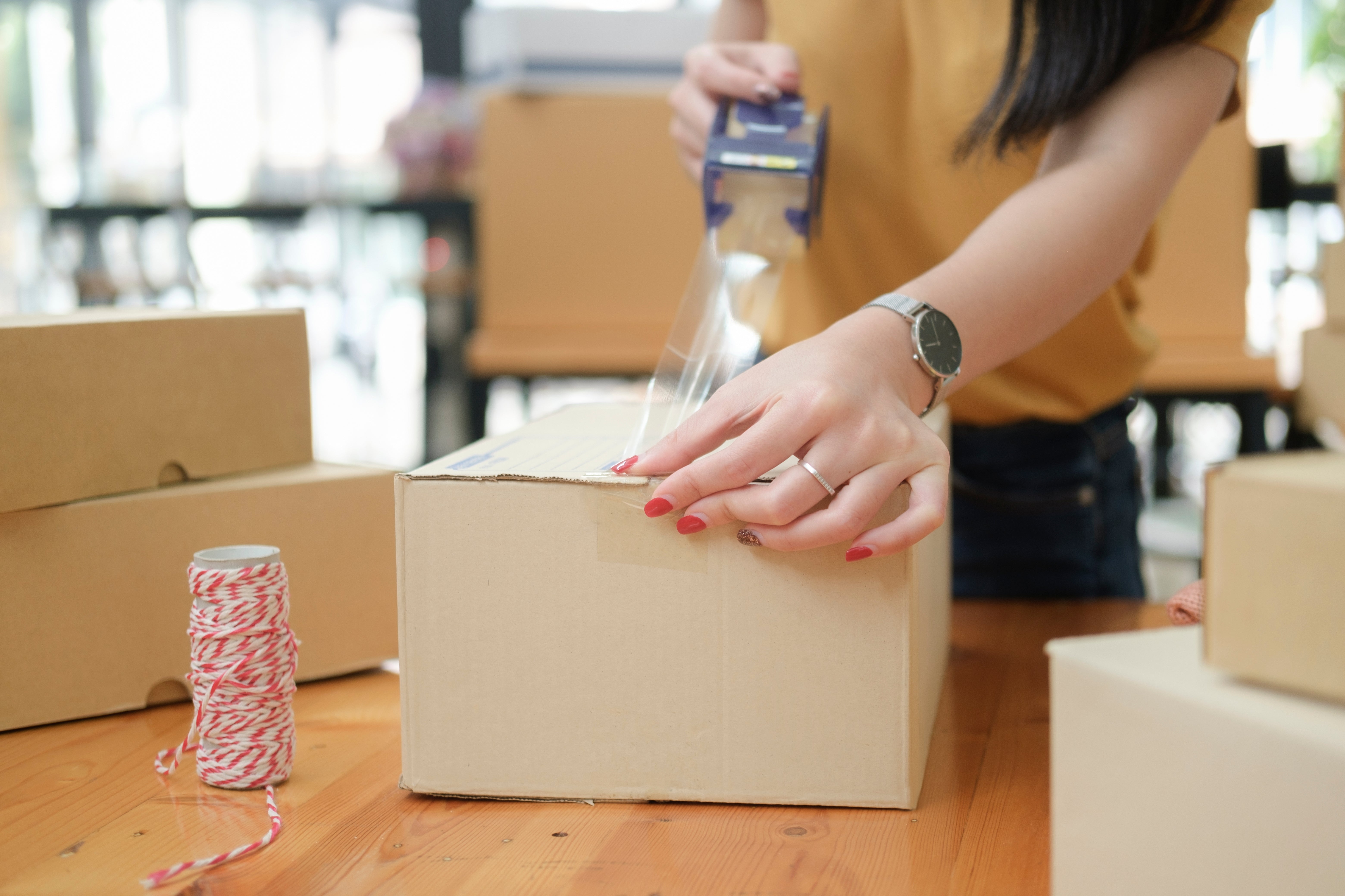 Ecommerce store owner preparing a package for shipping