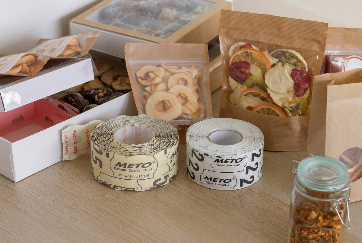 rolls of custom price gun labels in front of packages of dried fruit