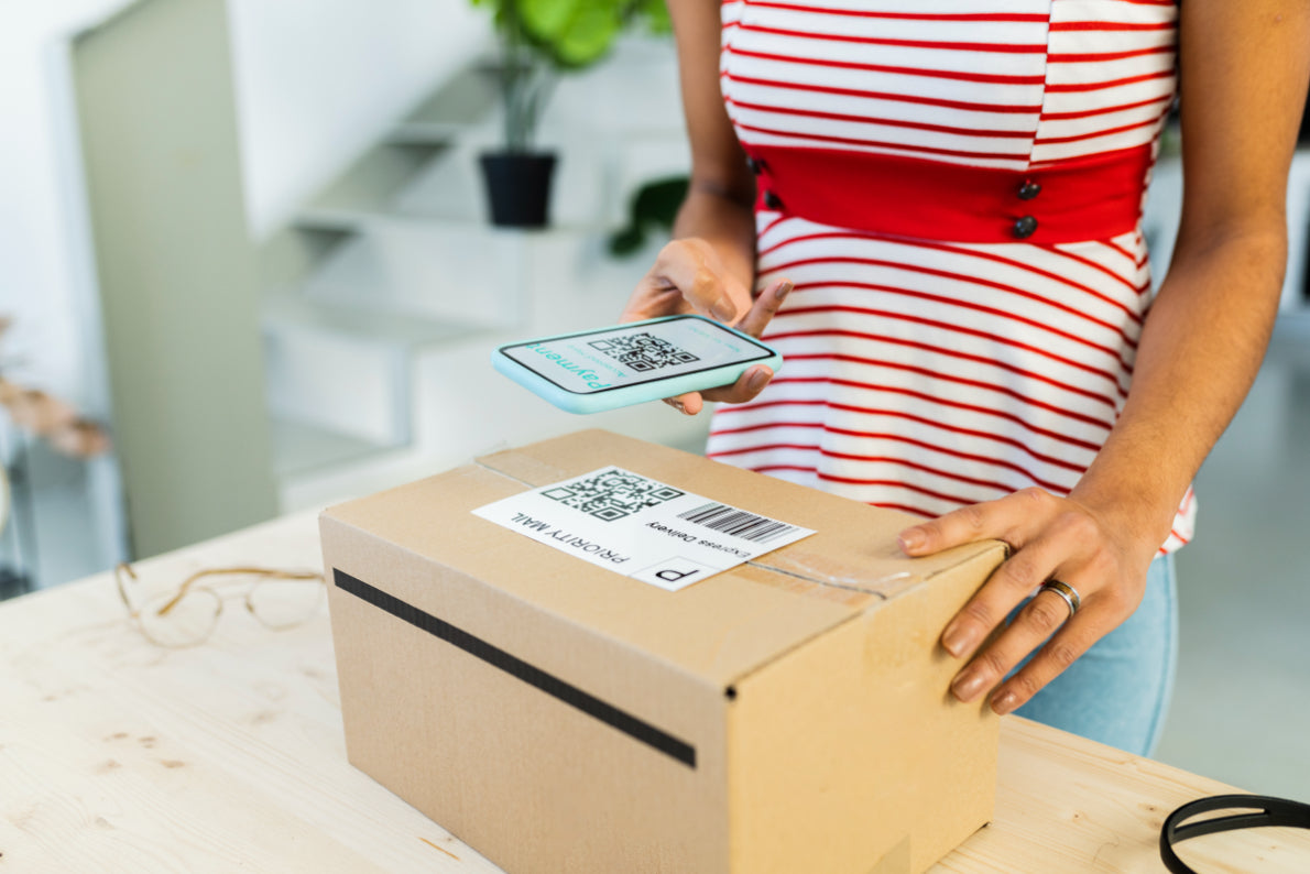 Person scanning a label on a package with a smartphone